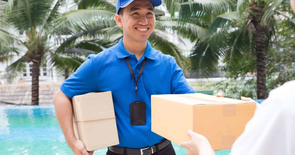 Woman hand accepting a delivery of boxes from deliveryman