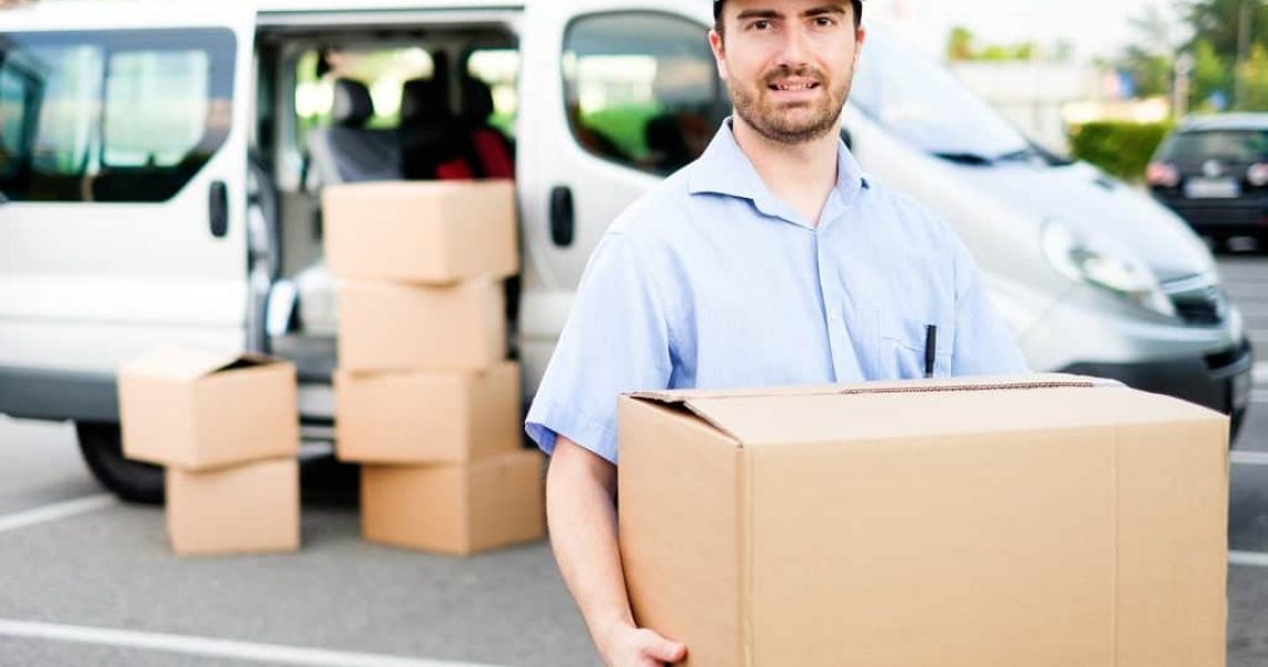 Portrait of confidence express courier next to his delivery van